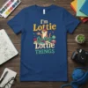 I'm Lottie Doing Lottie Things text with cute otter illustration on a navy blue t-shirt