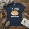 T-shirt with "I'm Lying While Lying" text and a sleeping cat graphic