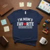 Navy t-shirt with white text: "I'm Mom's Favorite (She Told Me Not To Tell You)" and a red heart graphic