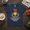 T-shirt with the text "I'm My Mother In Law's Favorite Child" and a golden trophy graphic with a red heart