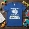 Blue t-shirt with the text "I'm not crazy I prefer the term MENTALLY HIALIROUS" and a brain graphic