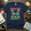 T-shirt with the quote "I'm Not Easy But We Can Discuss It" in bold red, yellow, and teal text, featuring