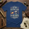 I'm Not Getting Old I'm Becoming A Legend quote with retro rocket graphic on a navy t-shirt