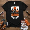 Black t-shirt with white and orange text "I'm Not Just His Mom I'm His Biggest Fan" featuring basketball graphics and
