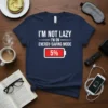 Navy t-shirt with white text "I'm Not Lazy I'm On Energy-Saving Mode 5%" and a red battery icon