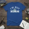 I'm Not Norm T-Shirt with a cartoon robot waving, white collegiate-style text on a royal blue shirt