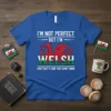 Royal blue t-shirt featuring bold white text "I'm Not Perfect But I'm Welsh" above a red Welsh dragon and the