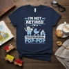 I'm Not Retired I'm A Profesesonal Pop-Pop t-shirt design featuring a grandfather holding a baby and a stroller