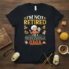 I'm Not Retired I'm A Professional Gaga t-shirt design featuring text and cartoon graphics of a grandmother holding a baby