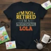 I'm Not Retired I'm A Professional Lola t-shirt with bold yellow and orange text, featuring vintage distressed style