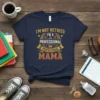 Navy t-shirt with "I'm Not Retired I'm A Professional Mama" text in distressed orange and gold, featuring laurel wreaths and