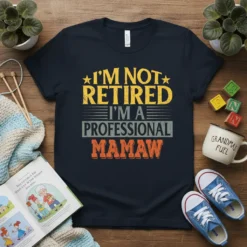 I'm Not Retired I'm a Professional Mamaw quote t-shirt in yellow, grey, and orange distressed text
