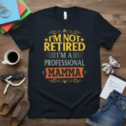 I'm Not Retired I'm A Professional Mamma text design on a black t-shirt, featuring yellow and orange typography with decorative