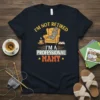 I'm Not Retired I'm A Professional Mamy t-shirt design with yellow armchair, coffee cup, and book graphic