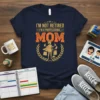 I'm Not Retired I'm A Professional Mom quote on a navy t-shirt, featuring a woman with shopping bags and cleaning