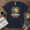 T-shirt with text "I'm Not Retired I'm A Professional Nooni" featuring a woman reading in a chair with golf clubs