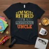 T-shirt with yellow and orange text reading "I'm Not Retired I'm a Professional Uncle" on a black shirt