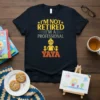 Graphic t-shirt with text "I'm Not Retired I'm A Professional Yaya" and illustration of a grandmother with two children