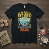 I'm Not Retired Professional Papa t-shirt design with a grandpa pushing a stroller and grilling