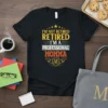 Black t-shirt with "I'm Not Retired Retired I'm A Professional Momma" text in yellow, white, and orange. Features star graphics
