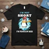 Black t-shirt with "I'm Not Short I'm Penguin Size" text and a cute penguin graphic on ice