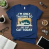 I'm Only Talking To My Cat Today text with a sleeping cat graphic on a navy blue t-shirt design