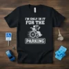 I'm Only In It For The Parking humorous quote design on a black t-shirt featuring a wheelchair user and a