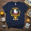 Navy blue t-shirt with "I'm QM's Favorite" text, a crowned cat on a cushion, a trophy, and laurel leaves