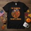 I'm Thankful I'm Not A Liberal funny Thanksgiving turkey t-shirt design with American flag hat and sunglasses