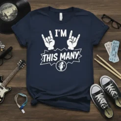 Navy t-shirt with white text "I'M THIS MANY" and rock on hand gestures, with a guitar headstock graphic