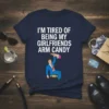 T-shirt featuring the quote "I'm Tired of Being My Girlfriends Arm Candy" with a cartoon man holding a purse