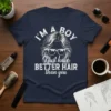 Navy t-shirt with white text "I'm a boy I just have BETTER HAIR than you" and graphic of stylish hair