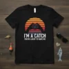 Fishing t-shirt with text "I'M A CATCH YOU'RE LUCKY TO HAVE ME" and heart hands over water graphic