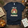 I'm A Fungi t-shirt with a cute smiling mushroom family in a green circle, surrounded by leaves
