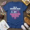 I'm A Grown Man My Daughter Wants quote on a blue t-shirt with pink and white text, featuring a family