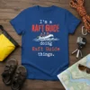 Blue t-shirt with red and white text "I'm a RAFT GUIDE doing Raft Guide things" and a graphic of people