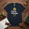 T-shirt with white text "I'm in charge." above crossed golden scepters, and a golden lion wearing a crown above the