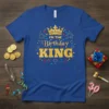 Blue t-shirt with gold glitter text "I'm the Birthday King" and a crown graphic with fireworks