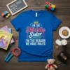 Blue t-shirt with the quote "I'm the Middle Sister I'm the Reason We Have Rules" in colorful typography, featuring a