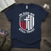In God We Still Trust t-shirt with American flag and cross graphic, navy blue tee