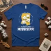 Mississippi state outline with magnolia flowers and "In God We Trust Mississippi" text on a blue t-shirt