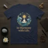 T-shirt with "in Harmony with Life" text and a circular graphic of a meditating figure, sun, waves, and leaves