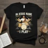 Christian t-shirt design featuring Jesus playing a drum set with the text "In Jesus Name I Play"