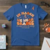 Blue t-shirt with "In March We Wear Orange" in retro font, featuring a DNA strand and butterfly graphic, with "developmental