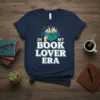 T-shirt with "In My Book Lover Era" text and an open book graphic, navy blue shirt