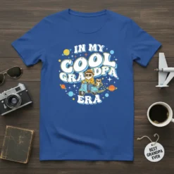 In My Cool Grandpa Era t-shirt design featuring a grandpa riding a scooter with a cat, surrounded by planets and