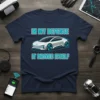 In My Defense It Drives Itself text with a futuristic electric car graphic on a navy t-shirt