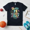 Retro graphic tee with text "In My PE Teacher Era" featuring sports icons like a jump rope, whistle, and running