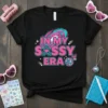 In My Sassy Era text design with pink and teal retro graphics, stars, and a disco ball on a black