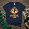 Black cat in a showgirl outfit holding a microphone, with text "In My Showgirl Era" on a navy t-shirt